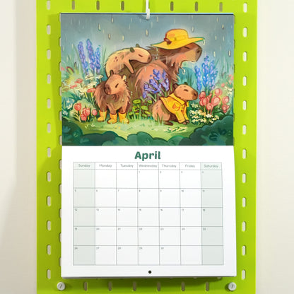Calendar with a cartoon capybara family illustration on a green background